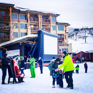 Open Air Cinema Event Pro 20' inflatable outdoor movie screen set up at a ski resort