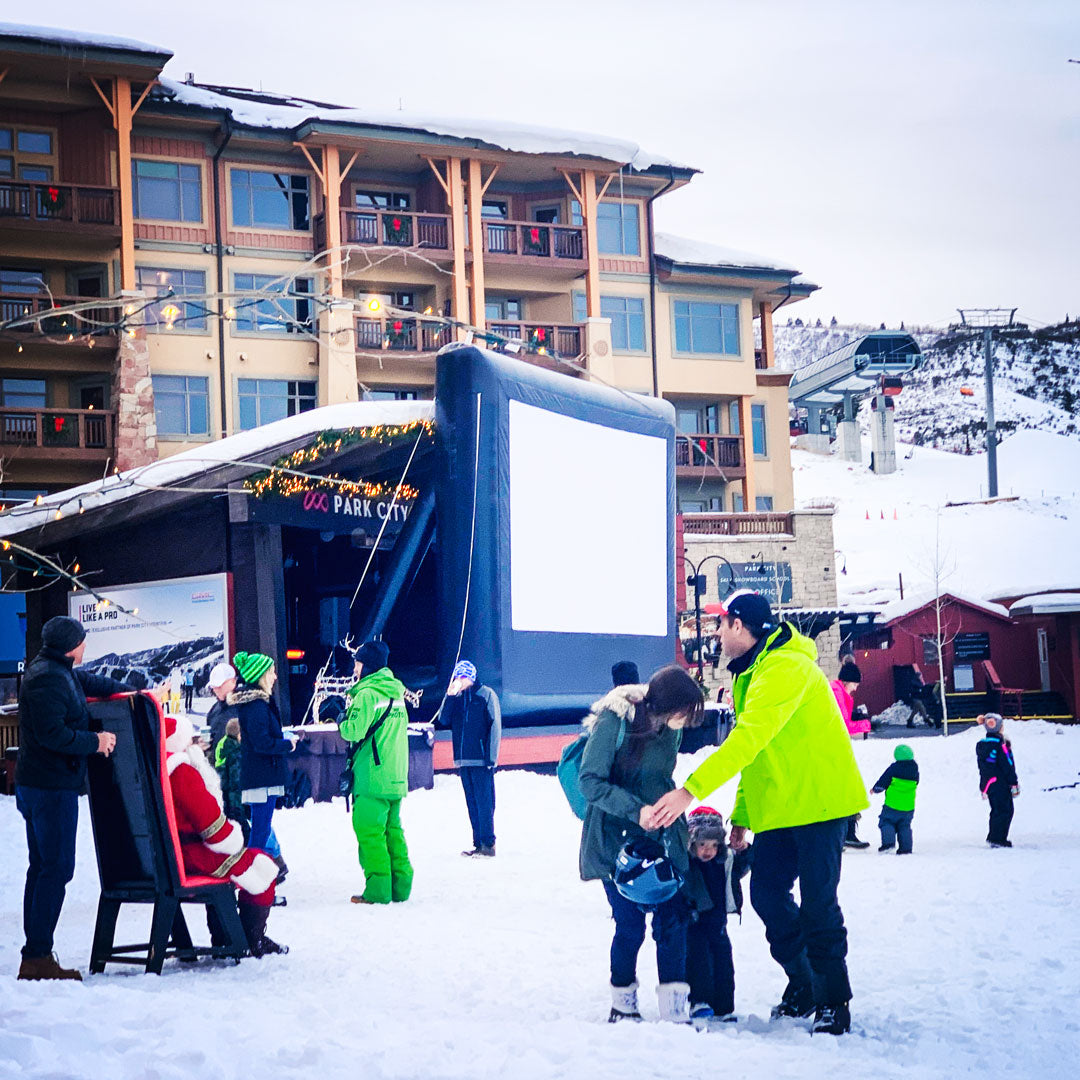 Open Air Cinema Event Pro 20' inflatable outdoor movie screen set up at a ski resort